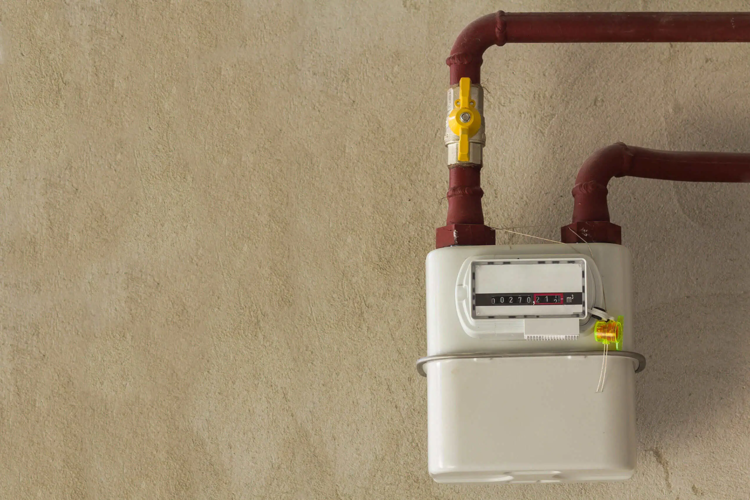 Gas meter with red pipes for home utility service.