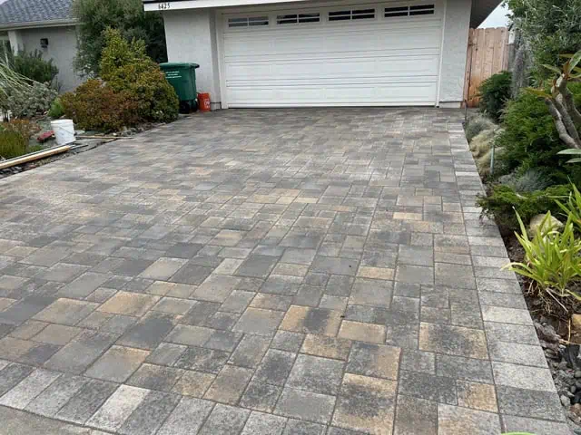 Driveway paving with interlocking stone bricks for a durable and attractive entrance.