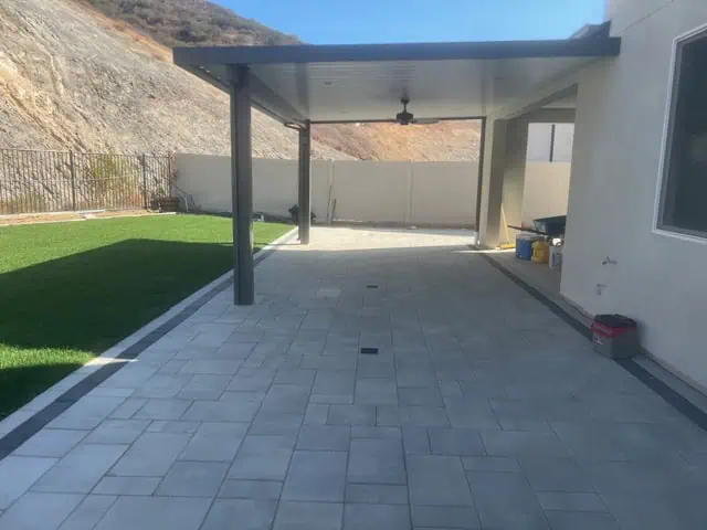 Covered patio with outdoor ceiling fan and durable tile flooring for outdoor living.